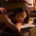 Couple enjoying a relaxing hot stone massage therapy at a spa for rejuvenation and self-care.