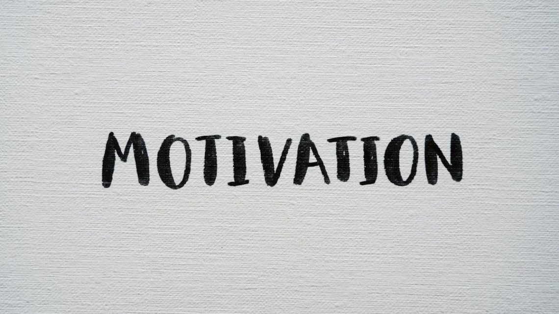 Inspirational word 'Motivation' in black on a white textured canvas background.